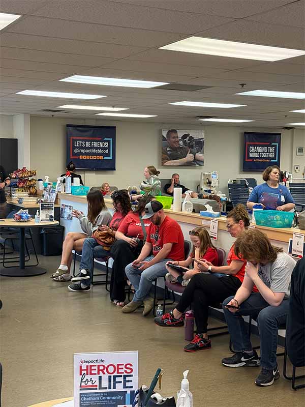 Group of young women with ImpactLife banner