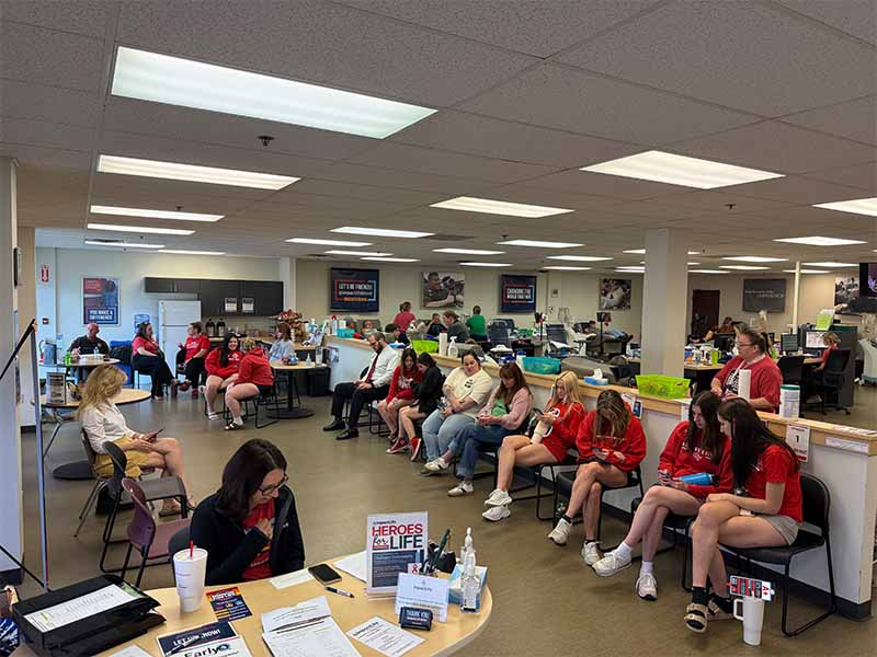Close-up of pink and purple 'SmileLikeZoey' bracelets