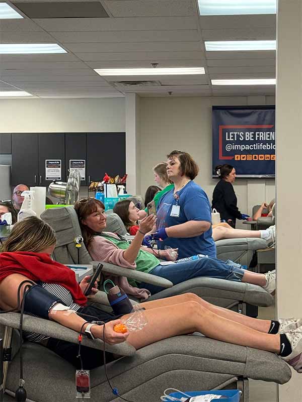 Wide shot of donors and staff at the event