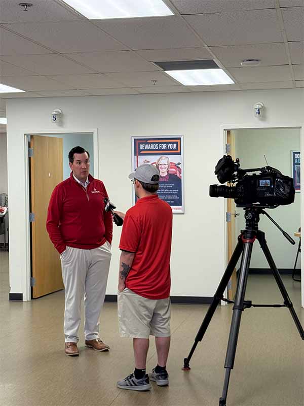 Two women talking at a table during the blood drive