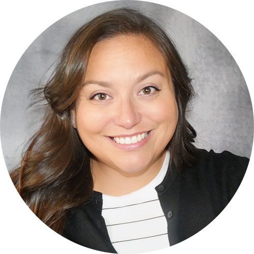 Smiling woman with long brown hair named Alli Woods, Director of Quality and Regulatory Affairs at ImpactLife