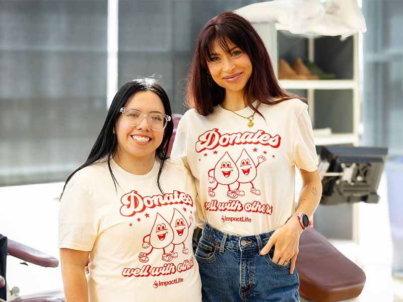 Two friends wearing ImpactLife shirts