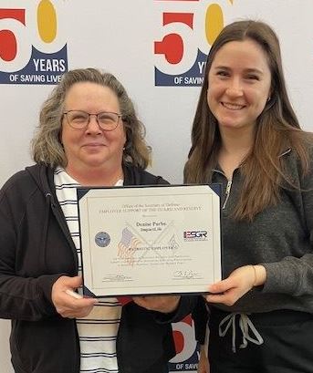 two females holding certificate