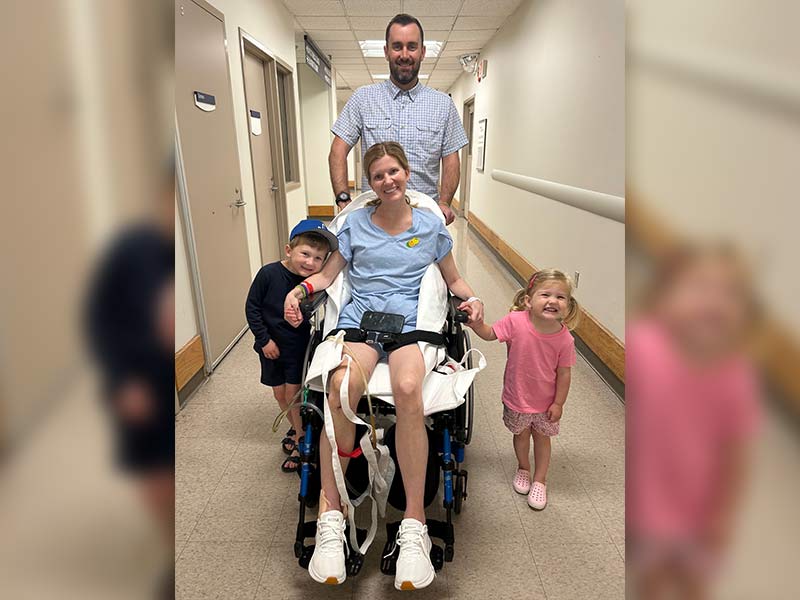 woman with family smiling to say thank you to the donors for their blood donations to ImpactLife