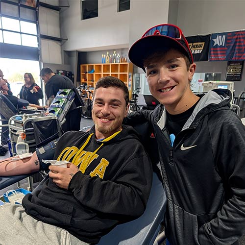 Young man standing next to a blood donor
