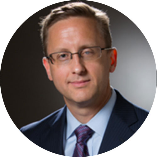 Man in suit wearing glasses smiling at camera named Stephen Hamborg for ImpactLife Board of Directors