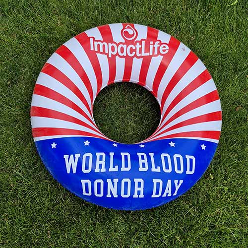 World Blood Donor Day pool float sitting on grass