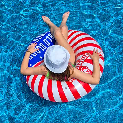 Girl on pool float in swimming pool