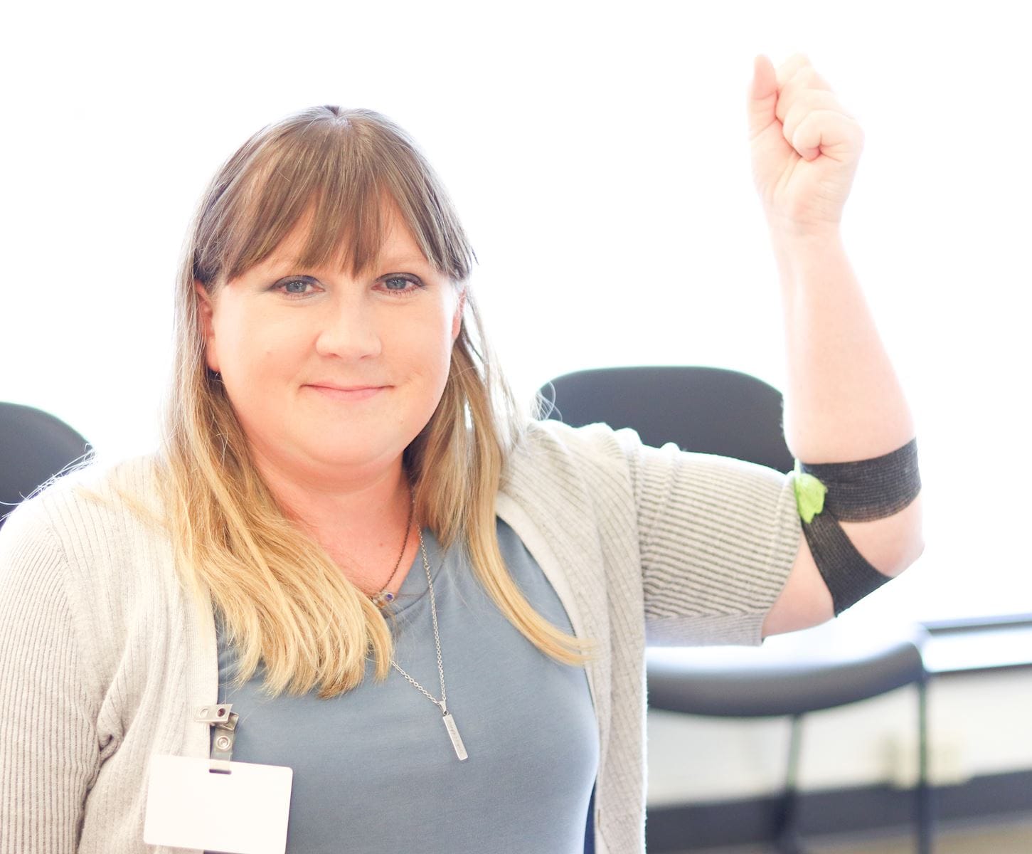 woman holding up arm after donating