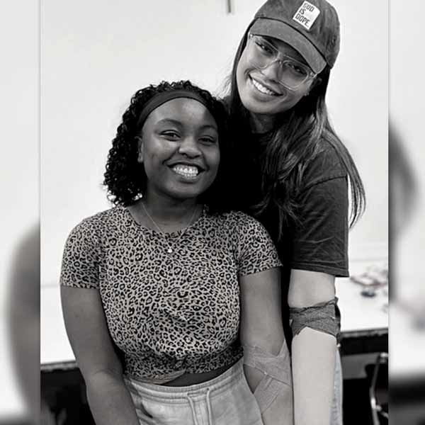 Girls smiling after donating blood and putting good into the world at impactlife