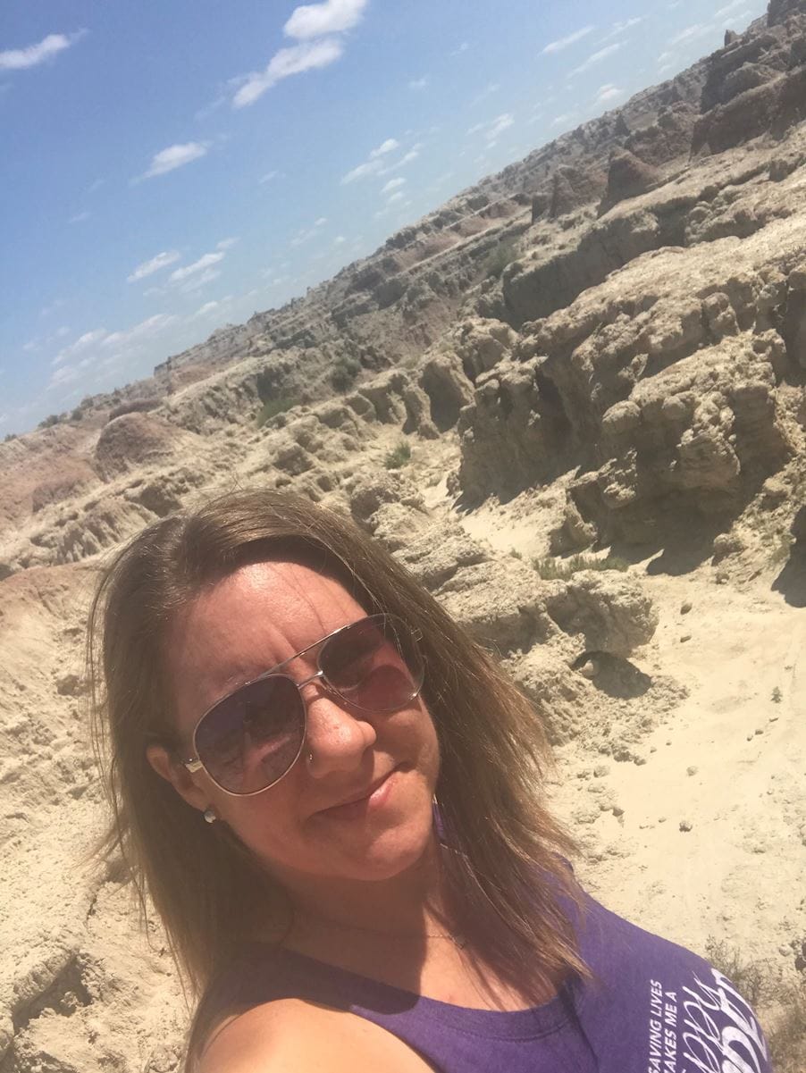 erin on mountain in blood center gear