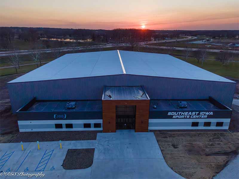 Aerial view of Southeast Iowa Sports Center building at sunset